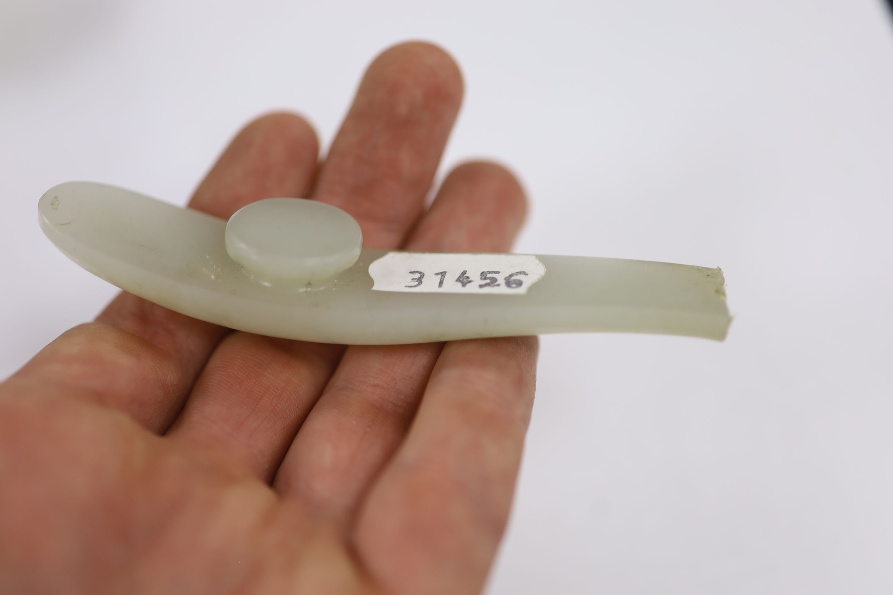 A Chinese pale celadon jade belt hook and a plaque